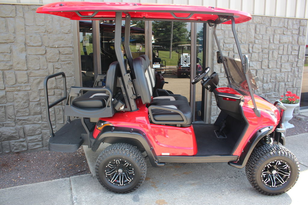 Red 2020 Star EV golf cart on a sidewalk in front of an office entrance.